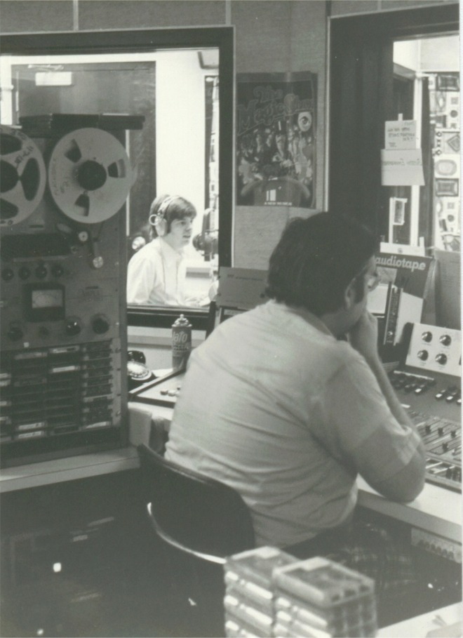 WRKO Engineer Dave Whalen runs Ron's news, readying to cue the jock through the glass after the newscast. The huge tape deck was used to record airchecks, etc.
